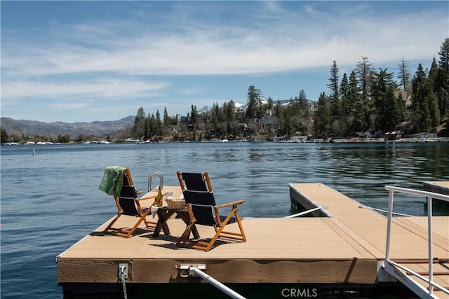 view of dock featuring a water and mountain view