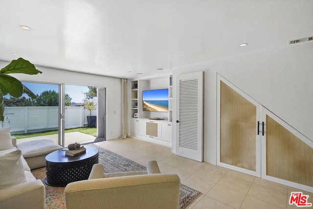 tiled living room featuring built in shelves