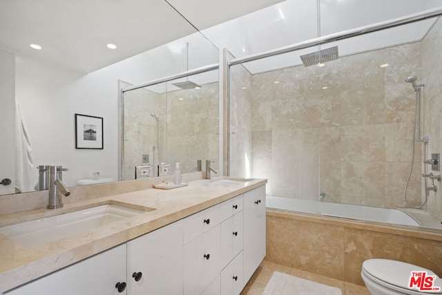 full bathroom featuring tile patterned flooring, toilet, enclosed tub / shower combo, and dual bowl vanity