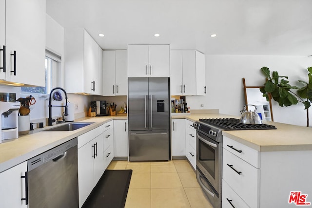 kitchen featuring sink, light tile patterned flooring, white cabinets, and stainless steel appliances