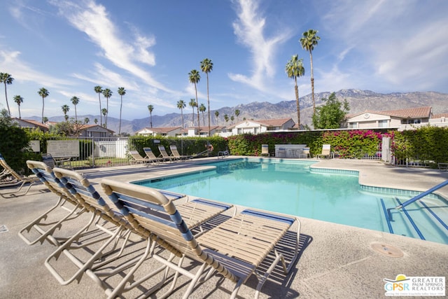 view of pool with a mountain view and a patio area