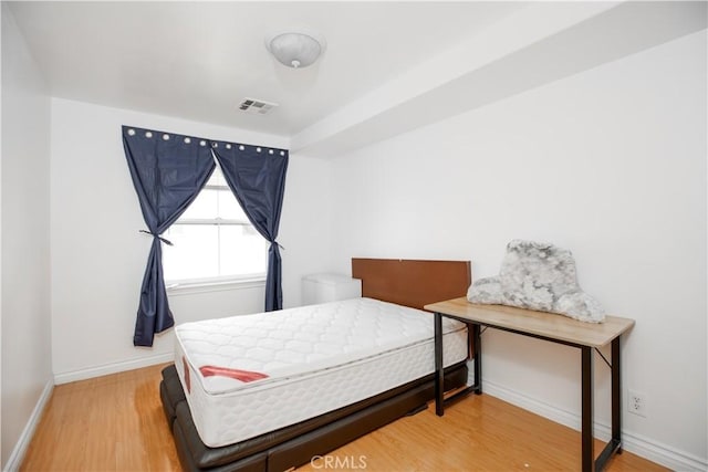 bedroom with hardwood / wood-style flooring