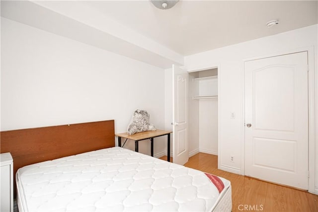 bedroom featuring a closet and hardwood / wood-style floors