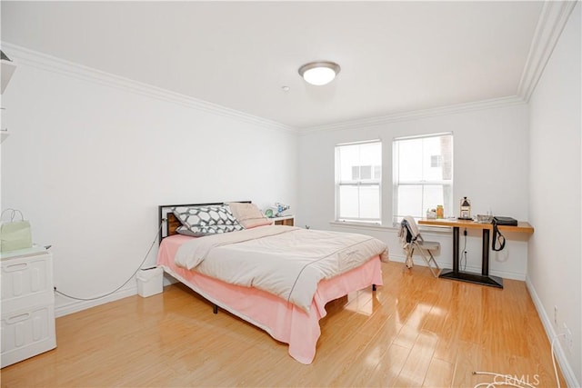 bedroom featuring crown molding and hardwood / wood-style flooring