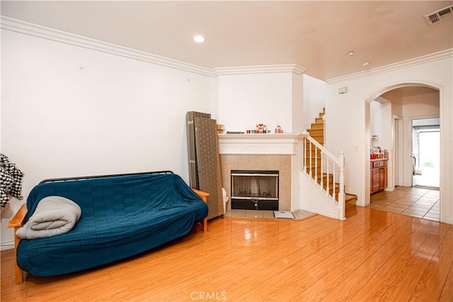 sitting room featuring wood-type flooring and ornamental molding