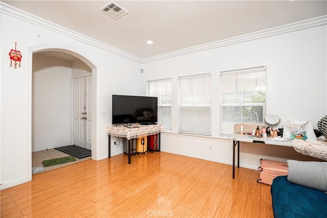 home office with wood-type flooring and crown molding