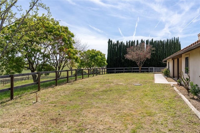 view of yard with a rural view