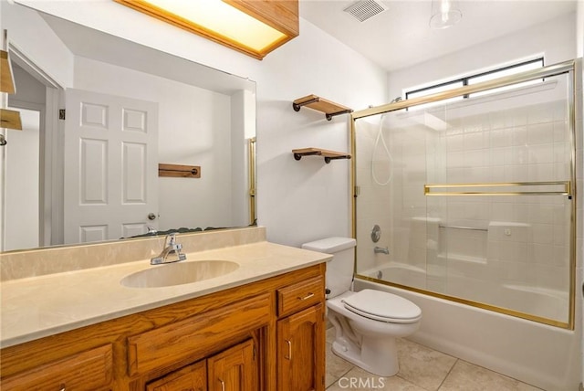 full bathroom with vanity, tile patterned flooring, toilet, and shower / bath combination with glass door