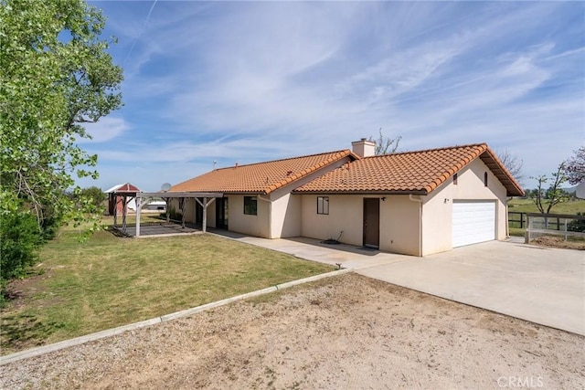 view of front of house with a carport, a front yard, and a garage