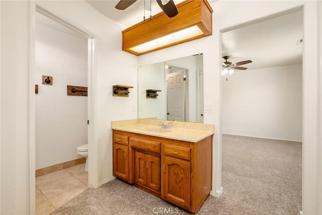 bathroom featuring toilet, tile patterned flooring, ceiling fan, and vanity