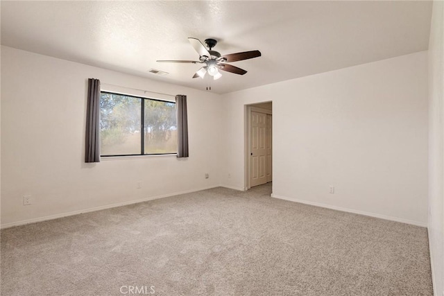 unfurnished room with ceiling fan and light colored carpet