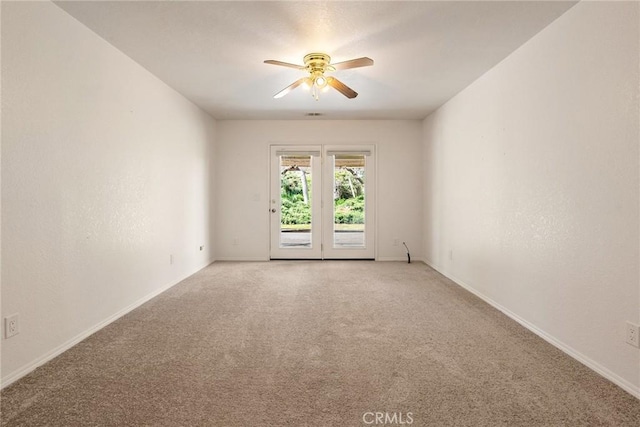 spare room featuring ceiling fan and light colored carpet