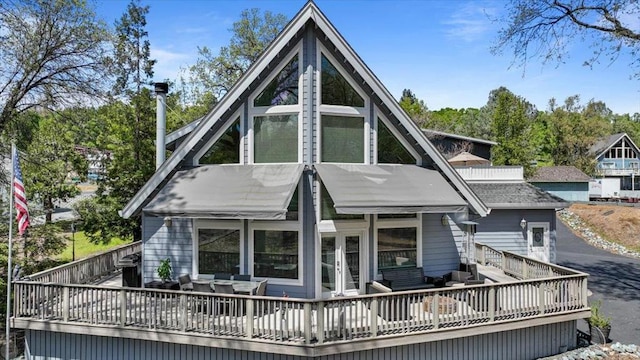 back of house featuring a deck