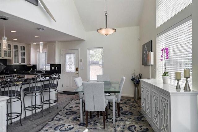 dining area featuring dark hardwood / wood-style floors and lofted ceiling