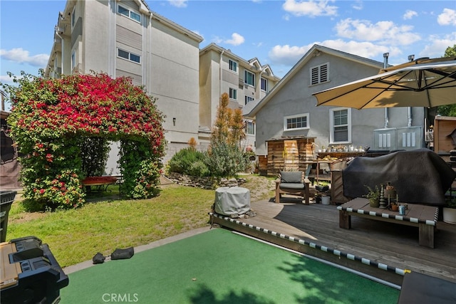 exterior space featuring a lawn and a wooden deck