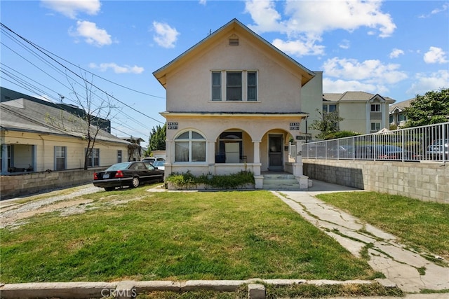 view of front of house with covered porch and a front yard