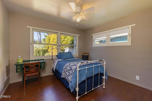 bedroom with ceiling fan and dark hardwood / wood-style floors