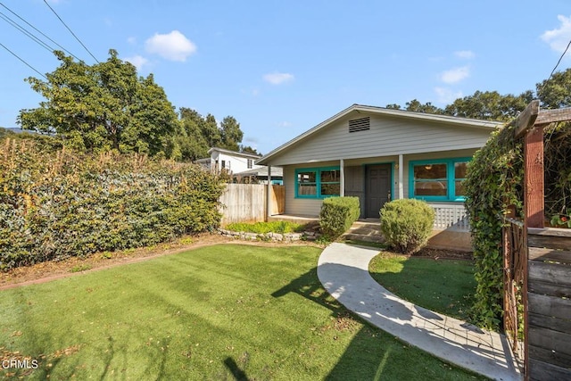 view of front of property with covered porch and a front yard