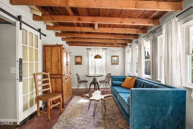 sitting room with beamed ceiling, plenty of natural light, a barn door, and wood ceiling