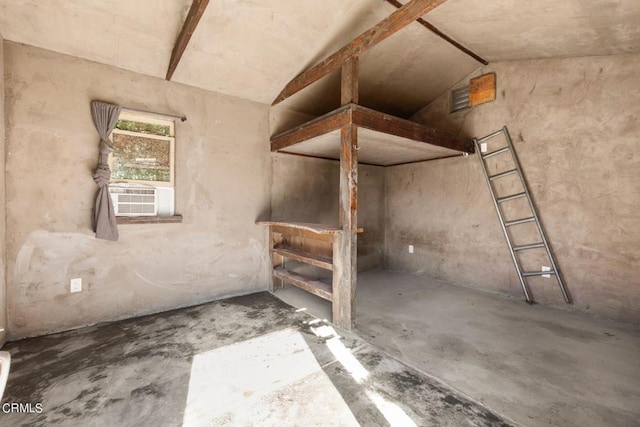 misc room featuring cooling unit, lofted ceiling, and concrete flooring