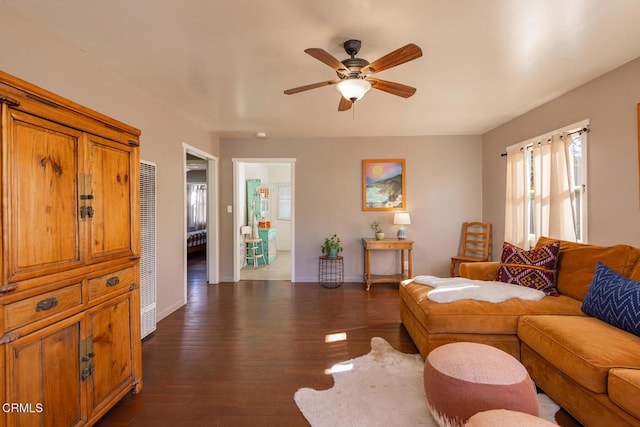 living room with ceiling fan and dark hardwood / wood-style flooring