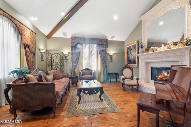 living room featuring hardwood / wood-style flooring and lofted ceiling with beams