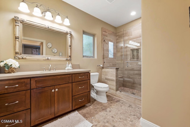 bathroom featuring tile patterned floors, vanity, a shower with door, and toilet