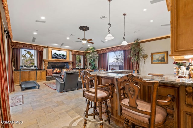 kitchen with light tile patterned floors, a healthy amount of sunlight, pendant lighting, and ceiling fan