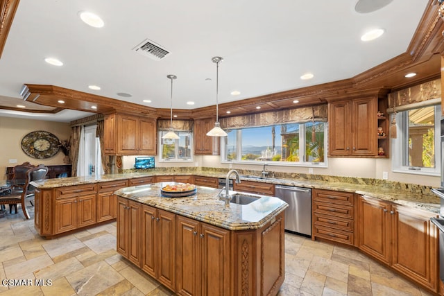 kitchen featuring hanging light fixtures, dishwashing machine, a wealth of natural light, and a center island with sink