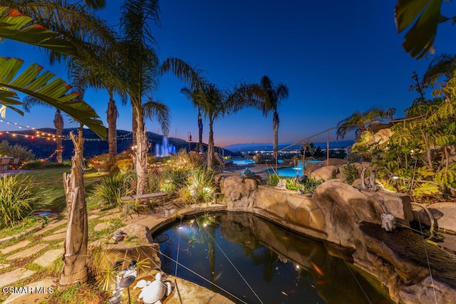 view of pool at dusk