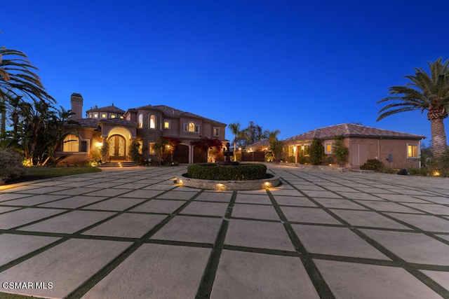 mediterranean / spanish home featuring a patio