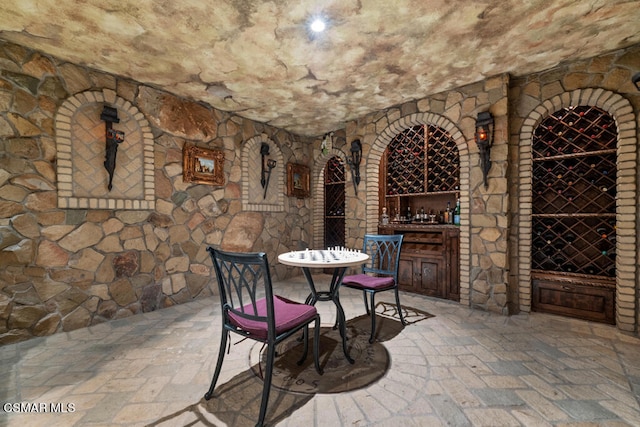 wine room featuring bar area