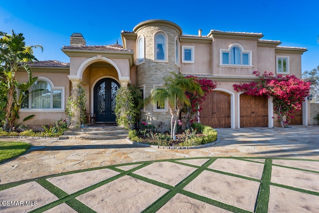 mediterranean / spanish home featuring a garage