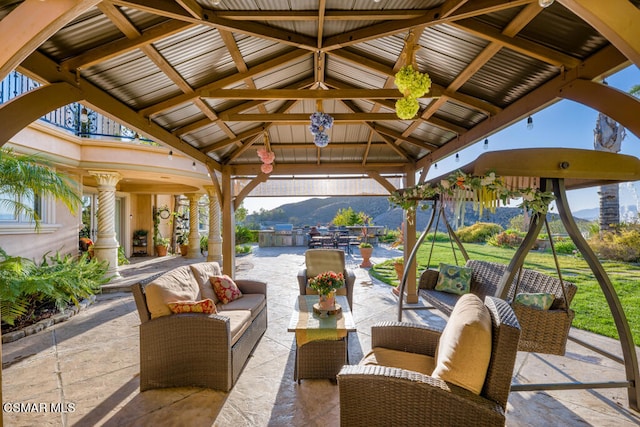 view of patio featuring an outdoor living space, a gazebo, and a mountain view