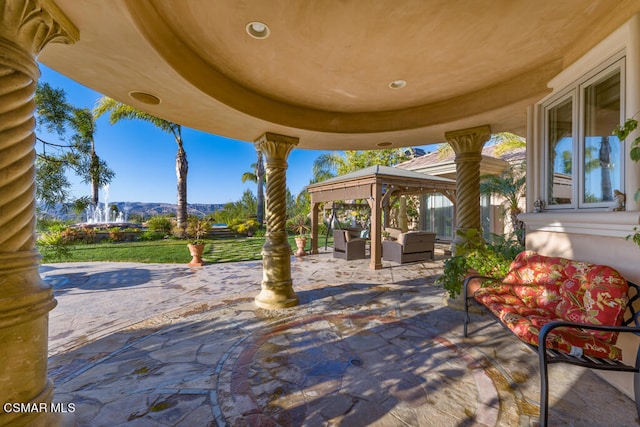 view of patio / terrace featuring a mountain view, a gazebo, and an outdoor living space