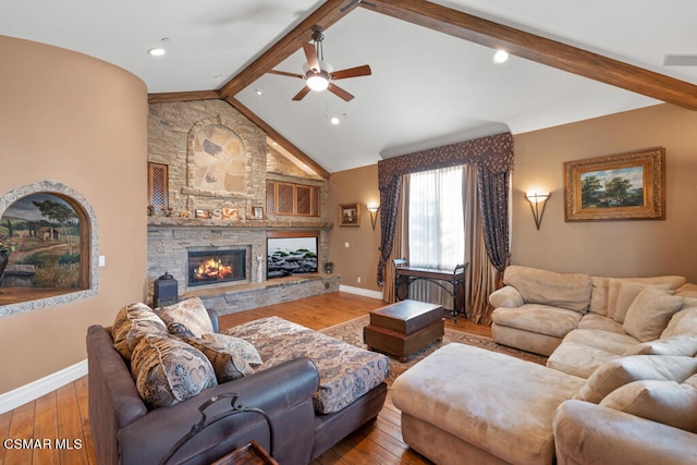 living room with beamed ceiling, a fireplace, wood-type flooring, and ceiling fan