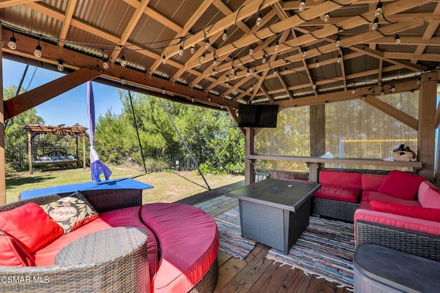 wooden deck featuring a gazebo and an outdoor living space