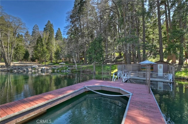 dock area featuring a deck with water view