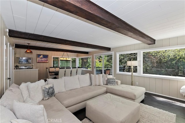 living room featuring wooden walls, beamed ceiling, and hardwood / wood-style flooring