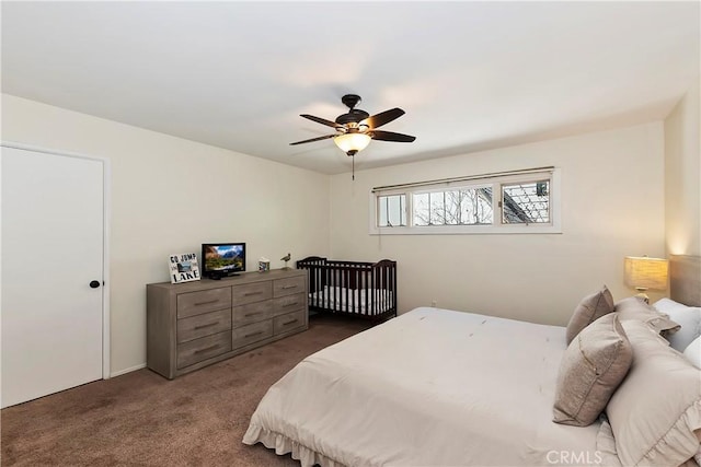 bedroom with ceiling fan and dark carpet