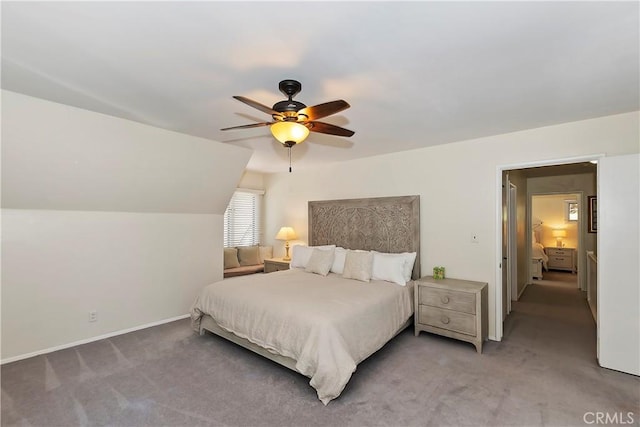 carpeted bedroom with ceiling fan and vaulted ceiling