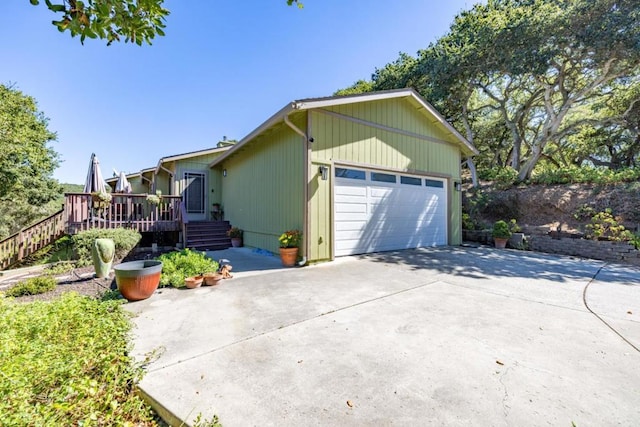 view of property exterior with a deck and a garage