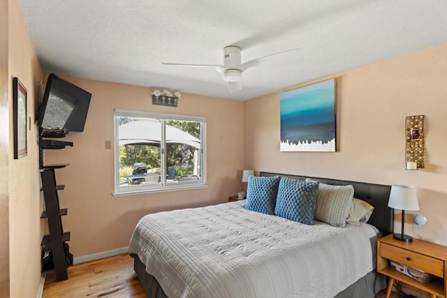 bedroom with ceiling fan and light hardwood / wood-style flooring