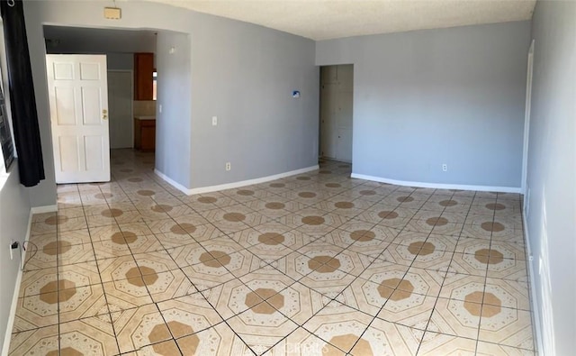 empty room with light tile patterned floors