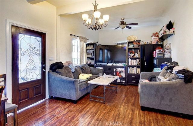 living room featuring dark wood-type flooring and ceiling fan with notable chandelier