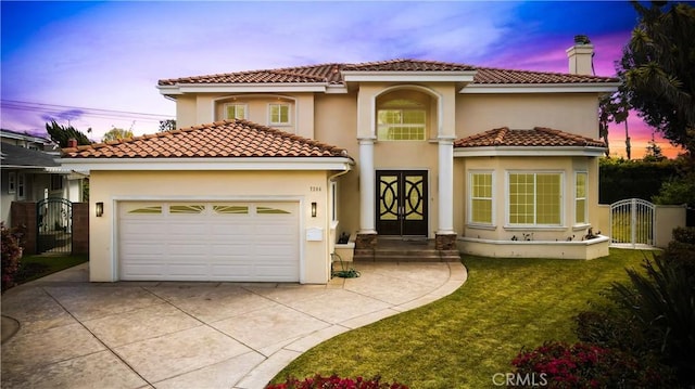 7264 W 88th Pl, Los Angeles, CA 90045 - mediterranean / spanish home featuring a gate, driveway, an attached garage, stucco siding, and a yard