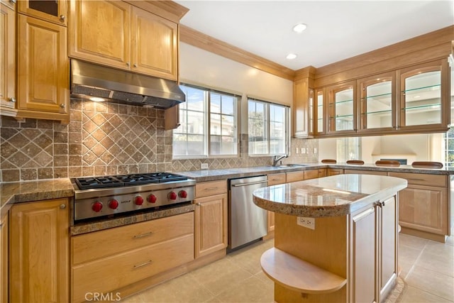 7264 W 88th Pl, Los Angeles, CA 90045 - kitchen with stainless steel appliances, under cabinet range hood, light tile patterned floors, glass insert cabinets, and ornamental molding