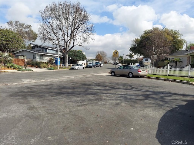 7264 W 88th Pl, Los Angeles, CA 90045 - view of asphalt street featuring curbs, traffic signs, and a residential view