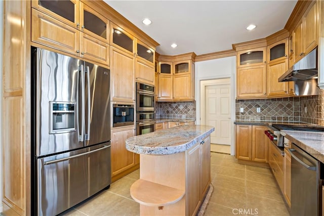 7264 W 88th Pl, Los Angeles, CA 90045 - kitchen with stainless steel appliances, under cabinet range hood, light tile patterned floors, light stone countertops, and tasteful backsplash