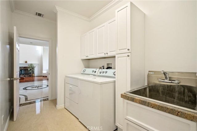 7264 W 88th Pl, Los Angeles, CA 90045 - washroom featuring washer and dryer, crown molding, baseboards, cabinet space, and light tile patterned floors